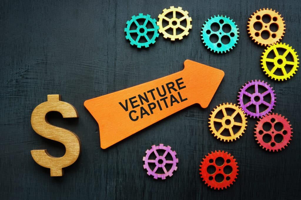 Venture capital concept. Dollar sign, arrow and gears.