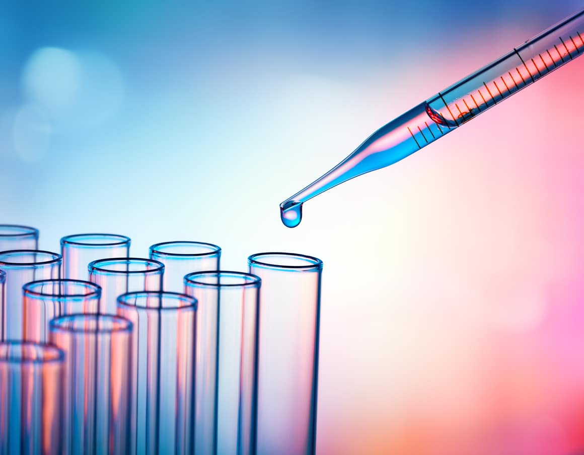 Pipette Dropping A Sample Into A Test Tube - Closeup